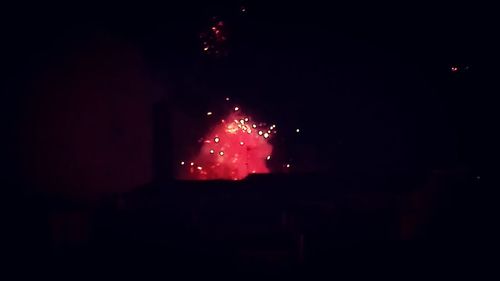 Low angle view of firework display at night