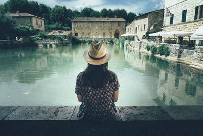 Rear view of woman in front of building