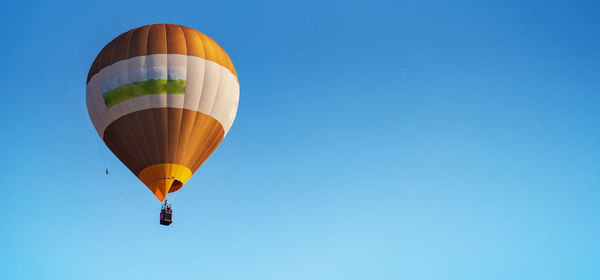 Low angle view of hot air balloon against blue sky