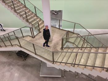 Rear view of woman walking on staircase