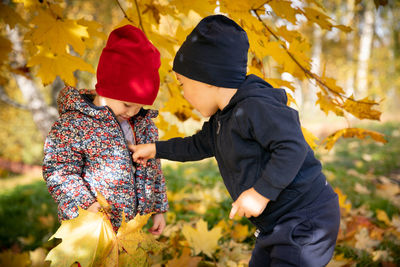 Rear view of couple standing in park