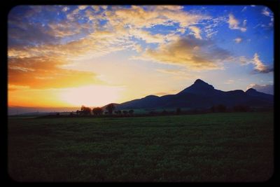 Scenic view of landscape against cloudy sky