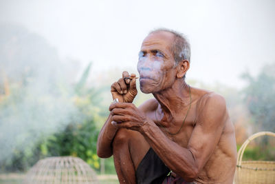 Portrait of man holding outdoors