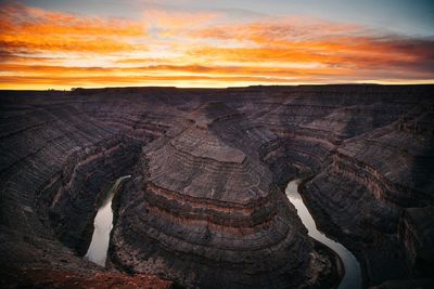 Aerial view of rock formations against sky during sunset