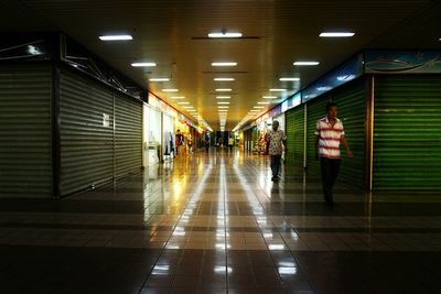 Narrow corridor along modern building