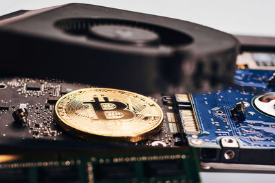 Close-up of bitcoin with computer equipment