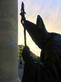 Low angle view of silhouette statue against sky during sunset