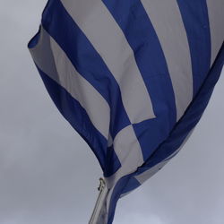 Low angle view of greece flag waving against clear sky