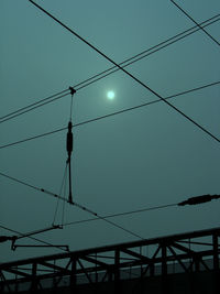 Low angle view of power lines against sky