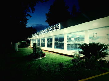 Illuminated built structure against sky at night