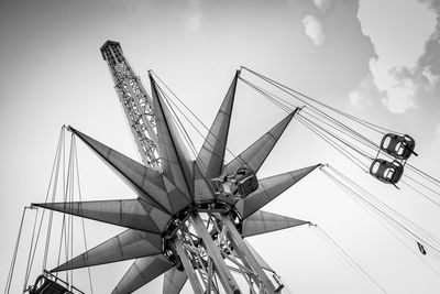 Low angle view of crane against sky