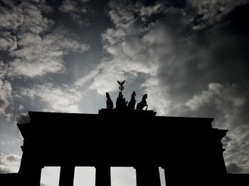 Low angle view of historical building against cloudy sky