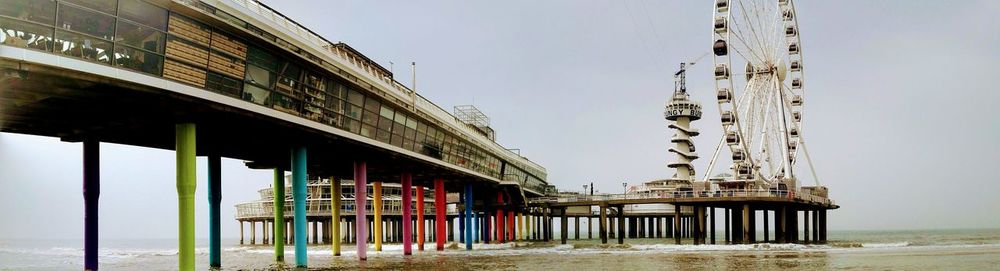 Built structure on pier by sea against clear sky