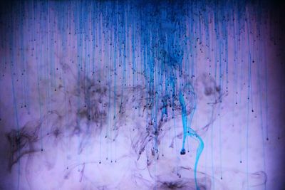 Full frame shot of blue ink mixing with water