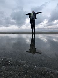 Man standing in sea against sky