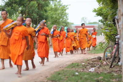 Rear view of people walking in temple