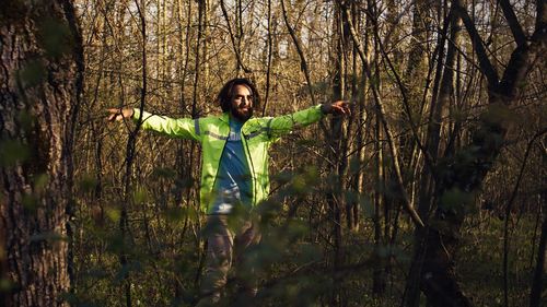 Full length of woman standing in forest