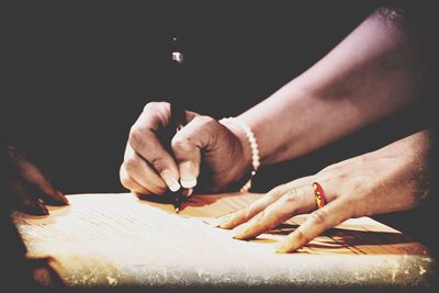 Midsection of man working on table