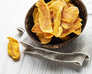 Dried mango fruit on old wooden background