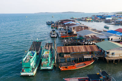 High angle view of harbor by sea against sky