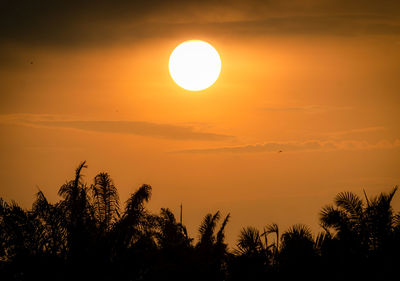Scenic view of silhouette trees against romantic sky at sunset