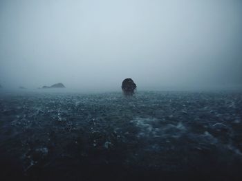 Scenic view of sea against stormy sky