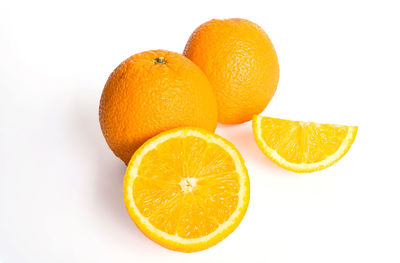 Close-up of orange fruit against white background