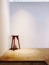 Chair on table against wall at home