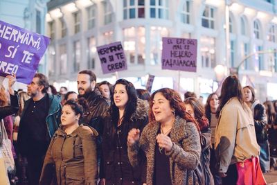 Group of people standing on street in city