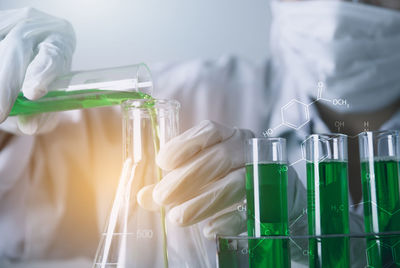 Digital composite image of man examining chemical in laboratory