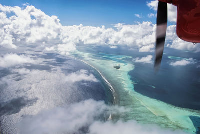 Low section of man on sea against sky