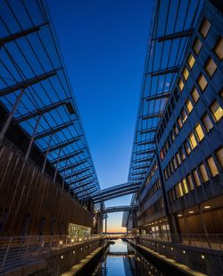 Low angle view of modern buildings against clear blue sky