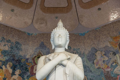 Low angle view of statue against temple