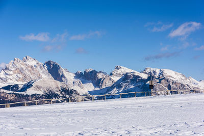 Scenic view of snowcapped mountains against blue sky