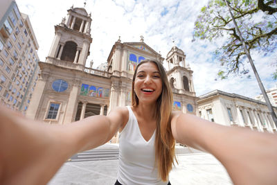 Self portrait of woman in porto alegre historic center with the cathedral, rio grande do sul, brazil