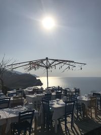 Scenic view of restaurant by sea against sky on sunny day