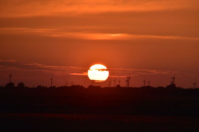 Silhouette landscape against sky during sunset