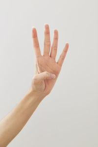 Close-up of hand over white background