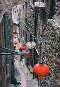 High angle view of lanterns hanging on footpath by building