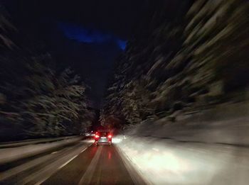 Cars on illuminated road at night