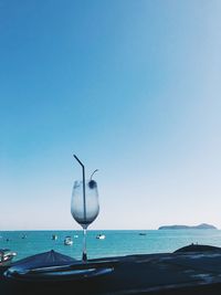 Seagull flying over sea against clear sky