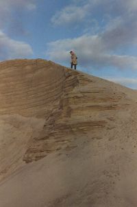 Man standing on desert against sky