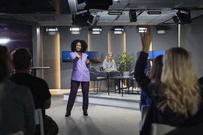 Tv show audience member raising hand