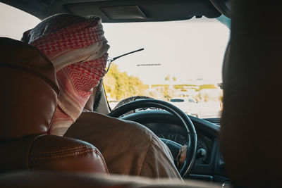 Rear view of man driving car