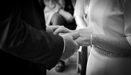 Midsection of couple holding hands