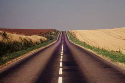 Road amidst landscape against clear sky