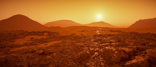 Scenic view of mountains against sky during sunset