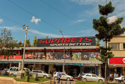 Information sign in city against sky