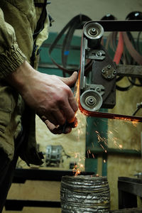 Midsection of man working in workshop