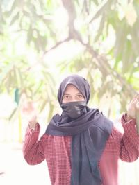 Portrait of a young woman standing outdoors